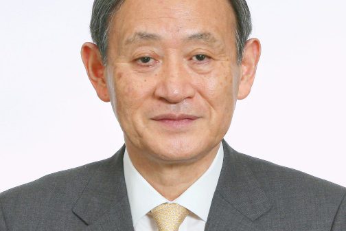 A person in a suit Description automatically generated with medium confidence