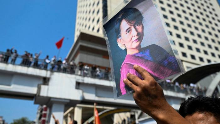 A protester holds up an image of ousted leader Aung San Suu Kyi during a demonsration in Yangon, Myanmar