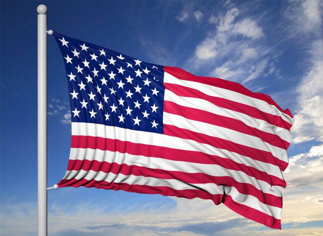 44876529 – waving flag of usa on flagpole, on blue sky background.